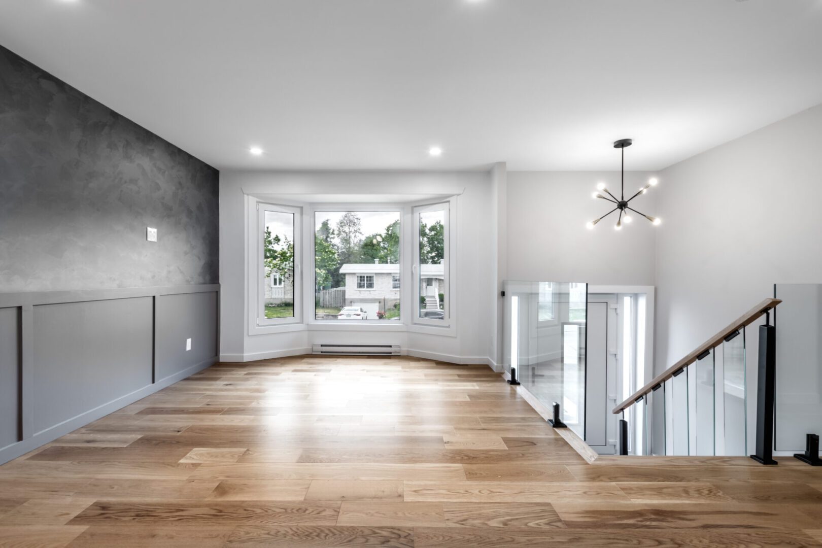 Modern living room with wooden floors and window.